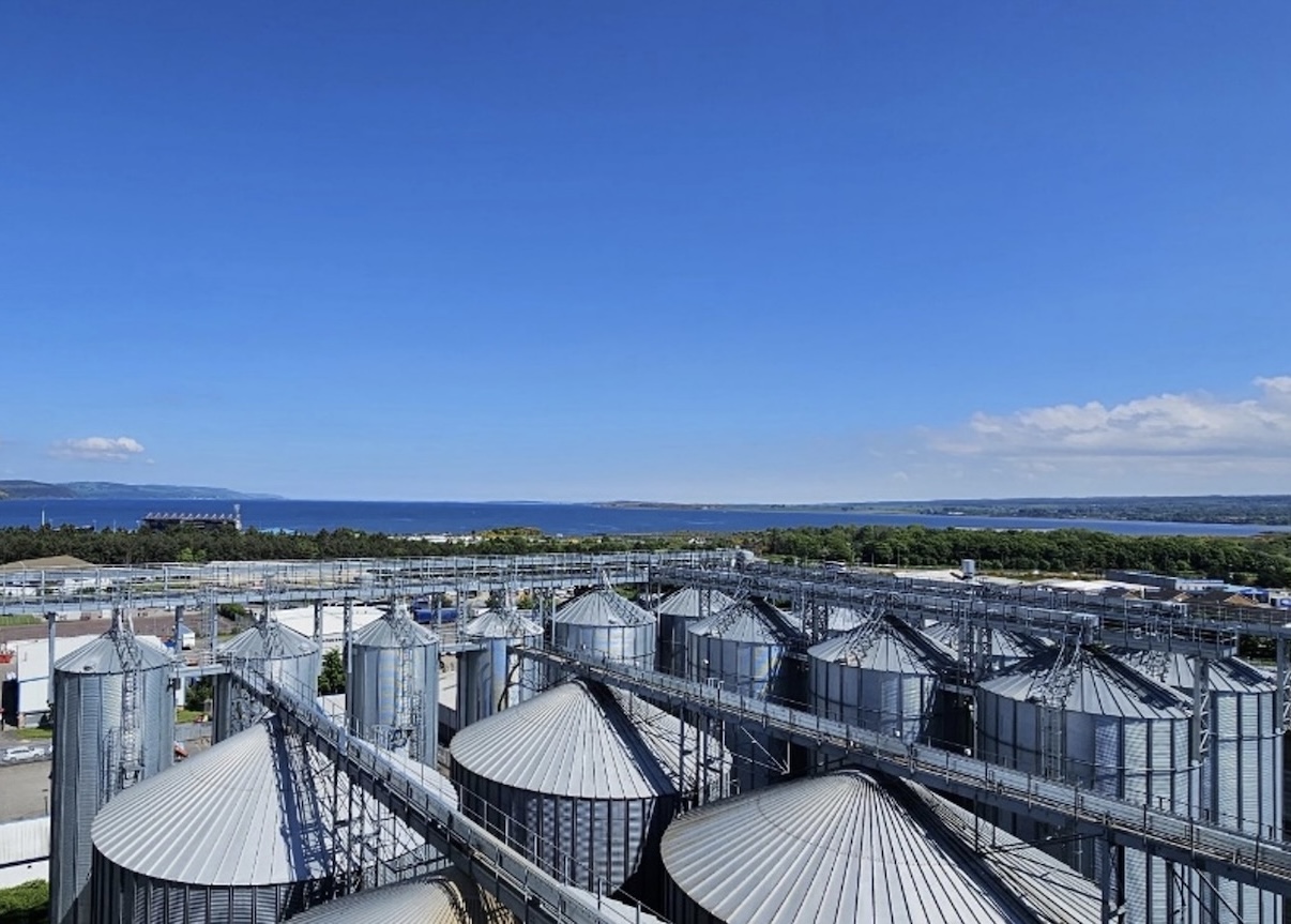 Grain silos at the Inverness malting plant with the Moray Firth behind
